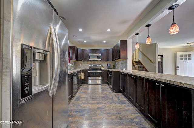 235 Oak Hill Rd, Hawley, PA 18428 - kitchen with dark wood-style flooring, dark brown cabinets, tasteful backsplash, a sink, and stainless steel appliances