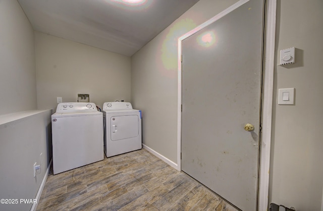 235 Oak Hill Rd, Hawley, PA 18428 - clothes washing area featuring independent washer and dryer, laundry area, baseboards, and wood finished floors