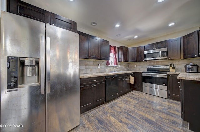 235 Oak Hill Rd, Hawley, PA 18428 - kitchen with a sink, appliances with stainless steel finishes, backsplash, and dark wood-style floors