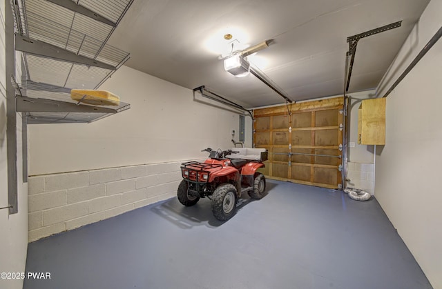 235 Oak Hill Rd, Hawley, PA 18428 - garage featuring concrete block wall, a garage door opener, and electric panel