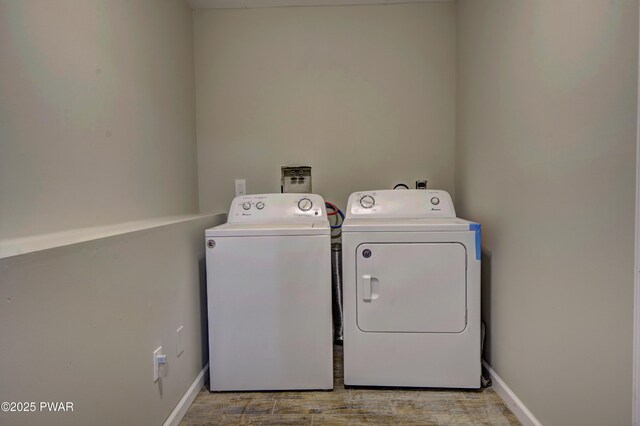 235 Oak Hill Rd, Hawley, PA 18428 - laundry area featuring laundry area, light wood-style flooring, baseboards, and separate washer and dryer