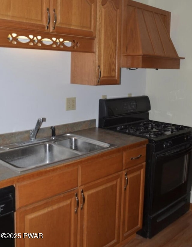 kitchen with hardwood / wood-style flooring, premium range hood, sink, and black appliances