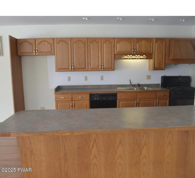 kitchen with sink, exhaust hood, and black appliances