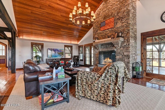 living room with a stone fireplace, plenty of natural light, high vaulted ceiling, and wooden ceiling