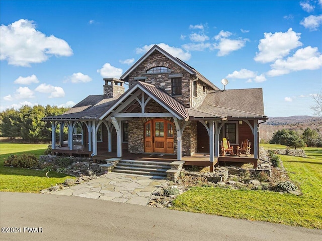 849 S Preston Rd, Lakewood, PA 18439 - view of front of house with stone siding, a porch, a front lawn, and a chimney