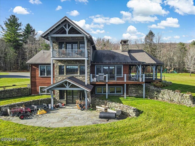 back of house with a yard, a balcony, and a patio area