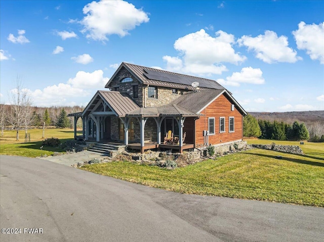 view of front of home featuring solar panels, covered porch, and a front lawn