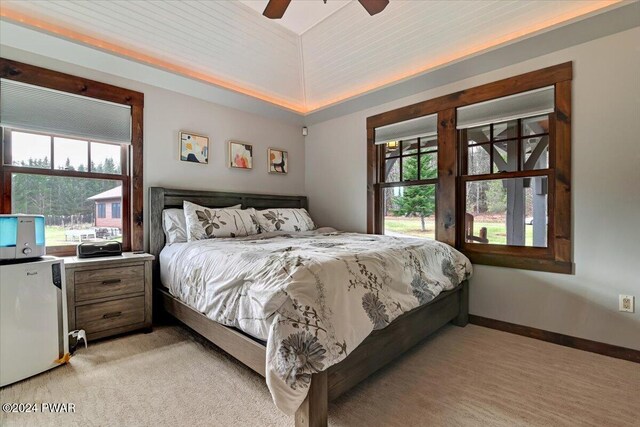 carpeted bedroom with ceiling fan, wood ceiling, fridge, and vaulted ceiling