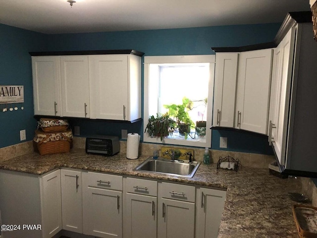 kitchen with white cabinets and a sink