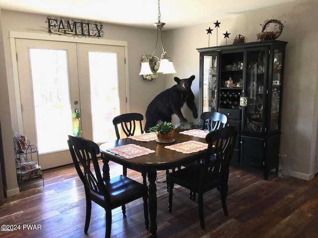 dining room with french doors, wood finished floors, and baseboards