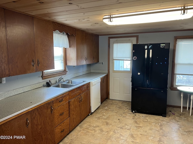 kitchen with a sink, wood ceiling, light countertops, freestanding refrigerator, and dishwasher