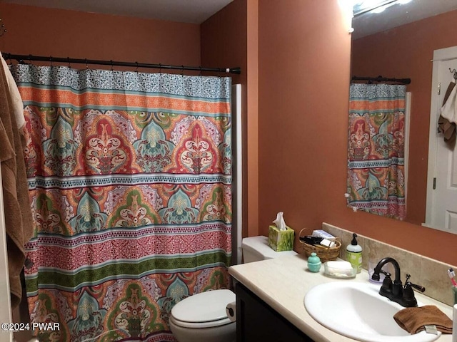 bathroom featuring a shower with curtain, vanity, and toilet