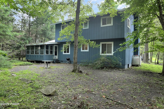 back of house with a sunroom