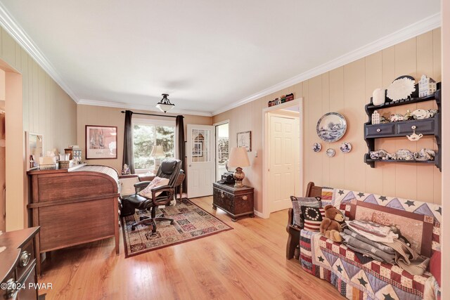 office area with light hardwood / wood-style flooring and crown molding