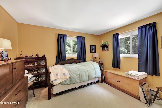 carpeted bedroom with wood walls