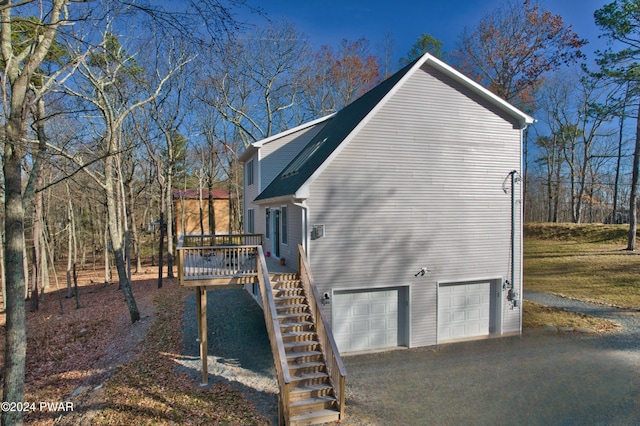 view of side of home with a garage and a deck