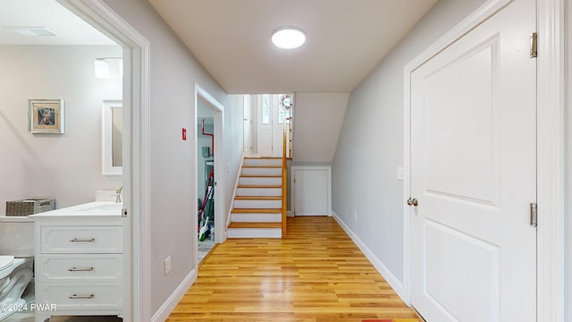 hallway featuring light wood-type flooring and sink