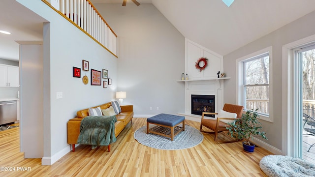 living room with light hardwood / wood-style floors and lofted ceiling