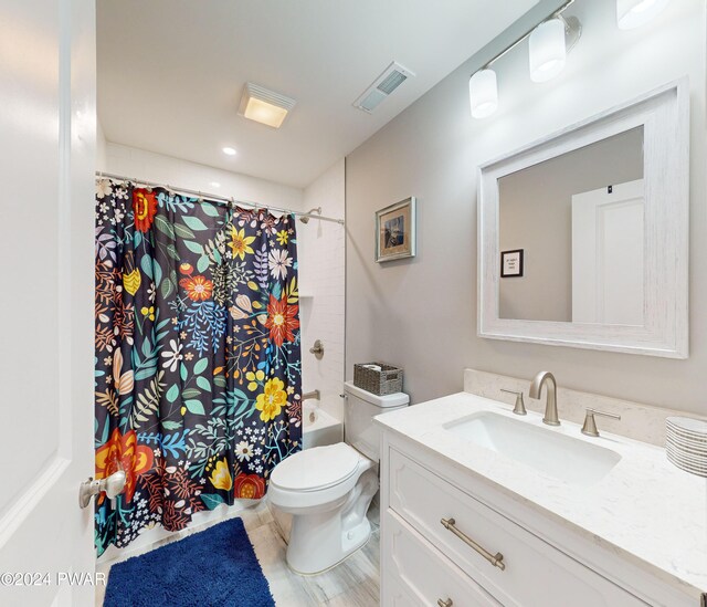 full bathroom featuring vanity, toilet, and shower / bath combo with shower curtain