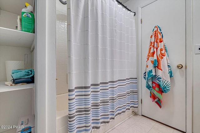 bathroom with shower / bath combination with curtain and tile patterned floors