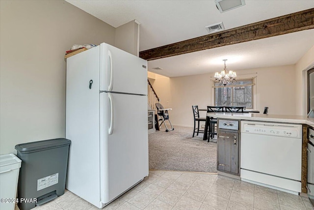 kitchen featuring hanging light fixtures, beamed ceiling, a notable chandelier, white appliances, and light carpet