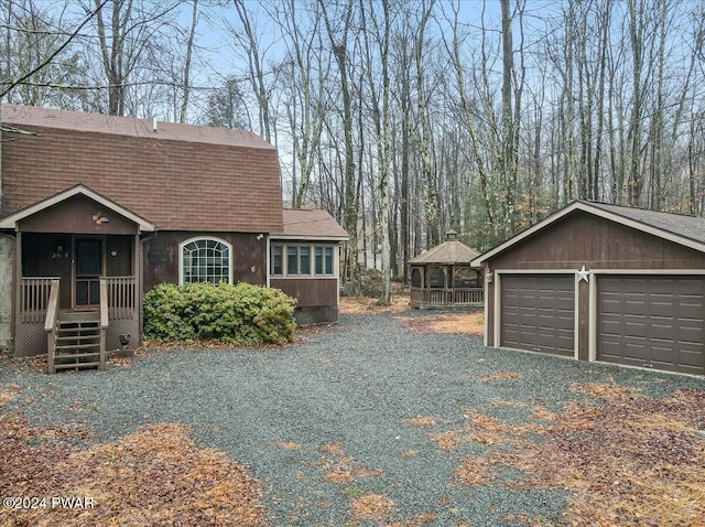 view of side of home with a garage and an outdoor structure