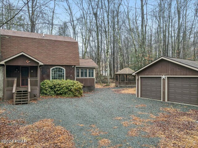 view of side of home with a garage and an outdoor structure