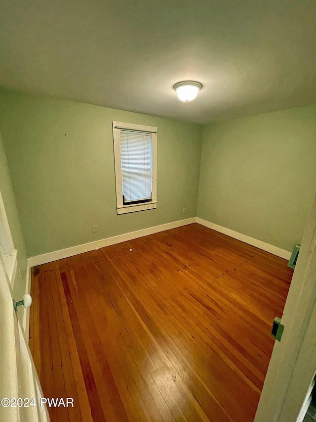 spare room with hardwood / wood-style floors