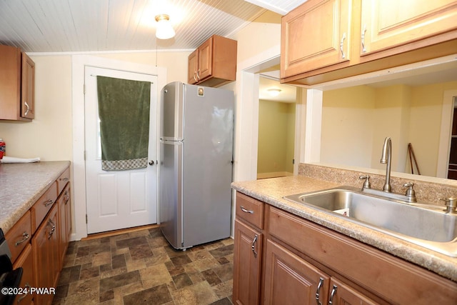 kitchen with stainless steel fridge, vaulted ceiling, wood ceiling, and sink