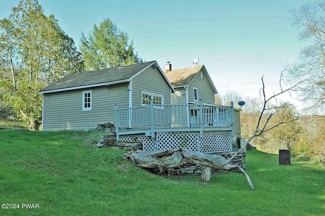 back of property featuring a yard and a deck