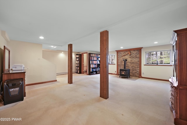 114 Wisener Ln, Shohola, PA 18458 - basement with a wood stove, light colored carpet, and baseboards