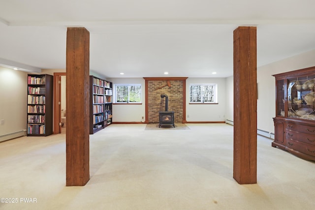 114 Wisener Ln, Shohola, PA 18458 - basement with baseboards, a wood stove, baseboard heating, carpet floors, and recessed lighting