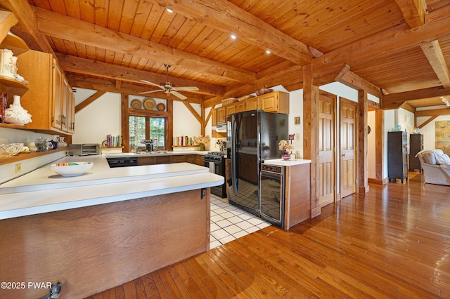 114 Wisener Ln, Shohola, PA 18458 - kitchen featuring a peninsula, light countertops, open shelves, light wood-style floors, and black appliances