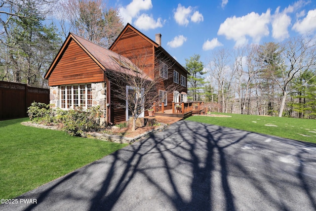 114 Wisener Ln, Shohola, PA 18458 - view of side of home with a yard, stone siding, a chimney, fence, and a wooden deck