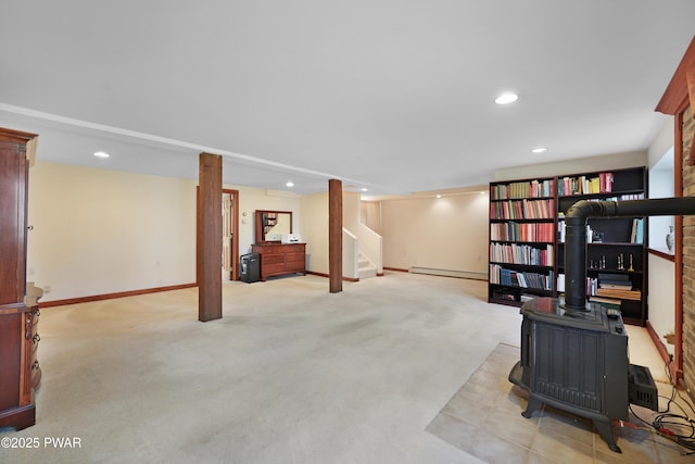 114 Wisener Ln, Shohola, PA 18458 - finished basement featuring a wood stove, carpet flooring, stairs, a baseboard radiator, and baseboards