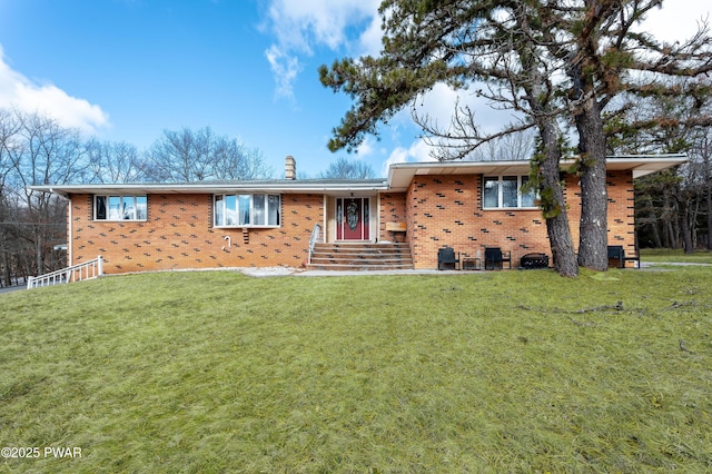 65 N Shore Dr, Albrightsville, PA 18210 - single story home featuring a front yard, a chimney, and brick siding