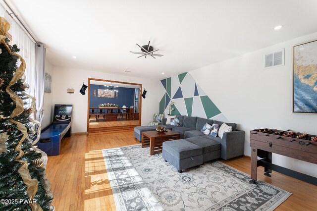65 N Shore Dr, Albrightsville, PA 18210 - living room featuring recessed lighting, an inviting chandelier, an accent wall, light wood-type flooring, and visible vents