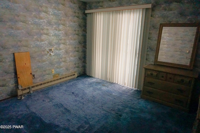 carpeted spare room with wallpapered walls and baseboard heating