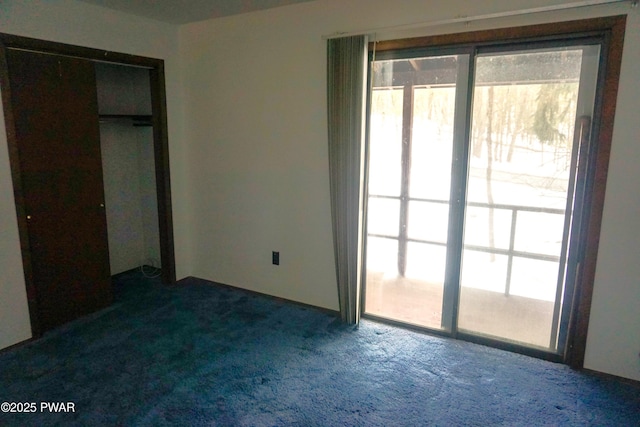 unfurnished bedroom with dark carpet