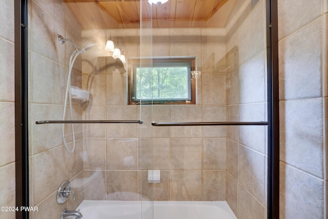 bathroom featuring wood ceiling and bath / shower combo with glass door