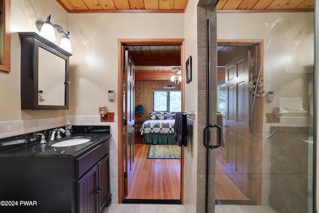 bathroom featuring tile patterned floors, vanity, wood ceiling, and walk in shower