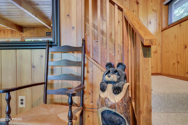 staircase with carpet, beam ceiling, wood ceiling, and wood walls