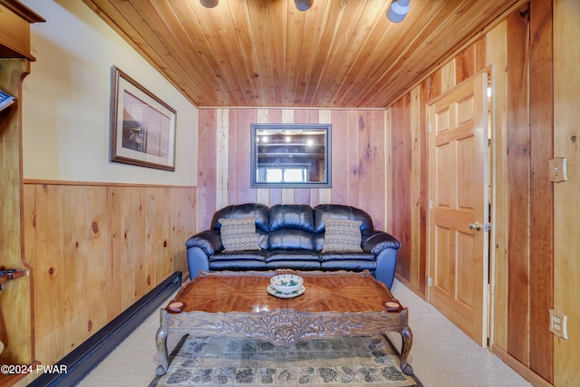 living room with carpet flooring, wood walls, and wooden ceiling