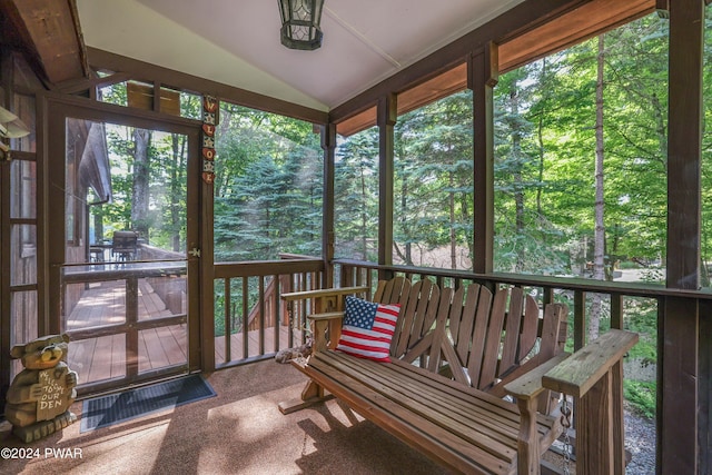 sunroom featuring lofted ceiling