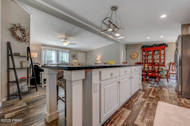 78 Orion Way, Lake Ariel, PA 18436 - kitchen featuring freestanding refrigerator, crown molding, white cabinetry, dark countertops, and dark wood-style flooring