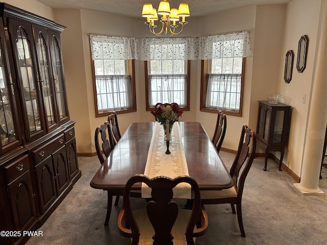 dining area featuring a wealth of natural light, a chandelier, and light colored carpet