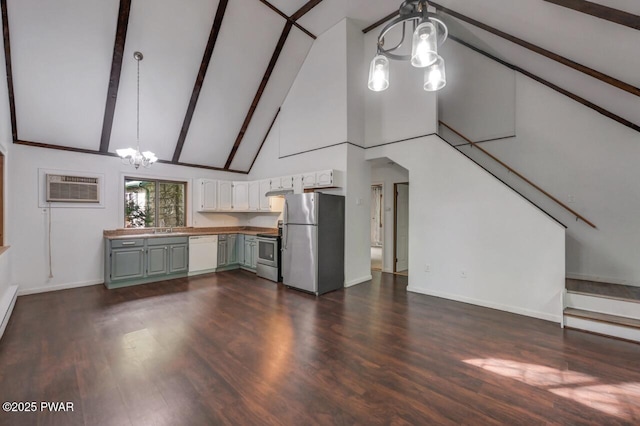 268 S Fairway Dr, Lake Ariel, PA 18436 - kitchen with stainless steel appliances, a chandelier, a wall unit AC, high vaulted ceiling, and dark wood-style flooring