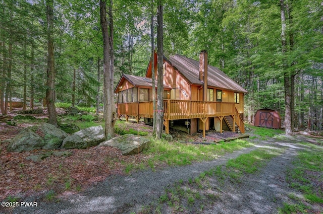 268 S Fairway Dr, Lake Ariel, PA 18436 - back of property featuring a sunroom, a storage unit, stairway, a chimney, and a wooden deck