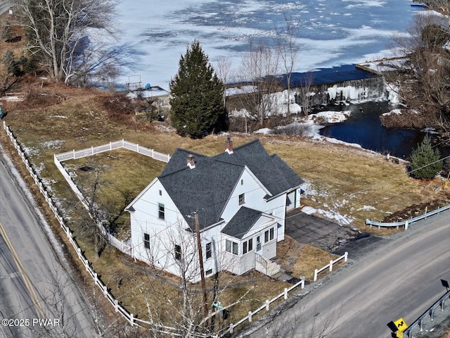 snowy aerial view with a water view