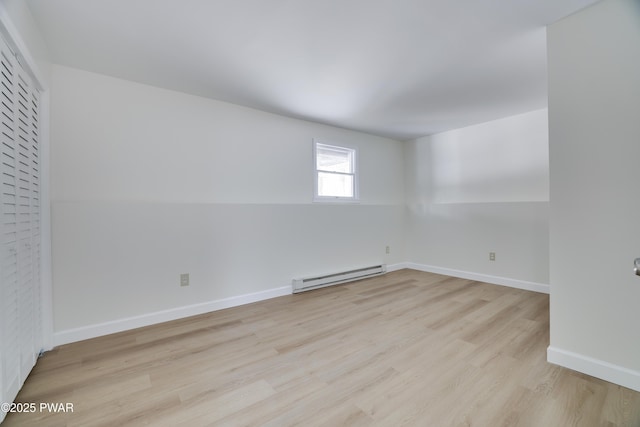 unfurnished room featuring light wood-style floors, baseboards, and baseboard heating
